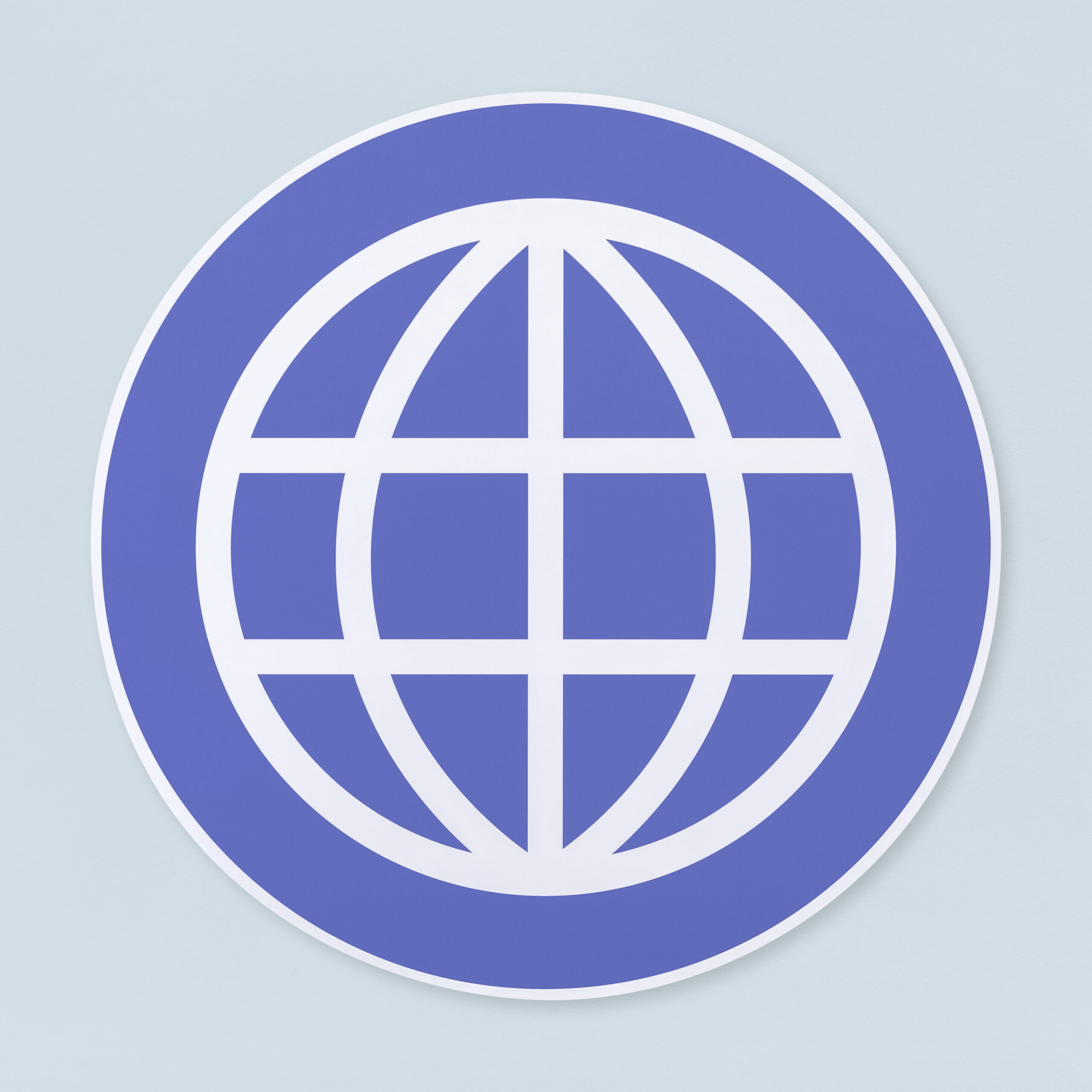 Partial close up of a blue circular logo with white curved lines forming a globe on a pale blue background